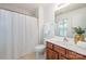 Bathroom featuring a tub, vanity with wooden cabinets, and a large mirror at 15554 Stronvar House Ln, Charlotte, NC 28277