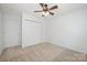 Bedroom featuring a ceiling fan, closet, and carpet at 15554 Stronvar House Ln, Charlotte, NC 28277