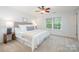 Bright bedroom featuring a ceiling fan, neutral carpet, and a window with natural light at 15554 Stronvar House Ln, Charlotte, NC 28277