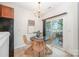 Cozy dining area with sliding door to outside, features stylish lighting and furniture at 15554 Stronvar House Ln, Charlotte, NC 28277
