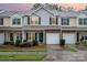 Charming townhouse with brick facade, garage, and well-maintained landscaping creates an inviting curb appeal at 15554 Stronvar House Ln, Charlotte, NC 28277