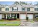 Charming townhouse with brick facade, garage, and well-maintained landscaping creates an inviting curb appeal at 15554 Stronvar House Ln, Charlotte, NC 28277