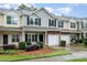 Townhouse exterior showcasing attached garage, landscaping, and neat curb appeal at 15554 Stronvar House Ln, Charlotte, NC 28277