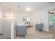 Upstairs living room features a white sofa, 2 arm chairs, and a glass coffee table at 15554 Stronvar House Ln, Charlotte, NC 28277