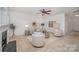 Neutral-toned living room features a fireplace and stylish furnishings and decor at 15554 Stronvar House Ln, Charlotte, NC 28277
