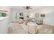 Bright living room boasts a fireplace, ceiling fan and neutral décor with stylish furnishings at 15554 Stronvar House Ln, Charlotte, NC 28277