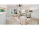 Bright living room boasts a fireplace, ceiling fan and neutral décor with stylish furnishings at 15554 Stronvar House Ln, Charlotte, NC 28277