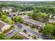 Aerial view captures well-maintained townhomes with manicured lawns, trees, and neighborhood streets at 15554 Stronvar House Ln, Charlotte, NC 28277