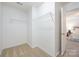 Spacious walk-in closet with carpet and metal shelving for organized storage at 15554 Stronvar House Ln, Charlotte, NC 28277