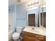 A full bathroom with single vanity, a tub-shower combo, and blue walls at 15623 Sir Charles Pl, Charlotte, NC 28277