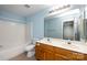 A full bathroom with double vanity, a tub-shower combo, and blue walls at 15623 Sir Charles Pl, Charlotte, NC 28277