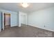 This bedroom features a mirrored closet, light blue walls, and gray carpeting at 15623 Sir Charles Pl, Charlotte, NC 28277
