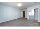Bedroom features light blue walls, carpeting, and a mirrored closet at 15623 Sir Charles Pl, Charlotte, NC 28277