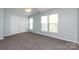 Bedroom with lots of natural light, neutral walls, and a ceiling fan at 15623 Sir Charles Pl, Charlotte, NC 28277