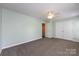 Bright bedroom with neutral walls, carpeted floors, ceiling fan, and double closet at 15623 Sir Charles Pl, Charlotte, NC 28277