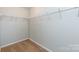 Walk-in closet with carpet flooring and built-in shelving at 15623 Sir Charles Pl, Charlotte, NC 28277