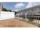 Wooden deck overlooking a row of townhomes with white privacy fences at 15623 Sir Charles Pl, Charlotte, NC 28277