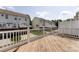 Back deck overlooks green space with a white fence, perfect for outdoor relaxation at 15623 Sir Charles Pl, Charlotte, NC 28277