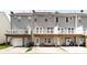 Rear view of townhomes showing decks, patios, and parking areas at 15623 Sir Charles Pl, Charlotte, NC 28277