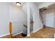 A bright hallway features wooden floors and a staircase with wooden banisters at 15623 Sir Charles Pl, Charlotte, NC 28277