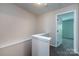 Second floor hallway with carpet and door leading to a bedroom at 15623 Sir Charles Pl, Charlotte, NC 28277