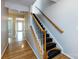 Open hallway with hardwood floors featuring a stairway and views into adjacent rooms at 15623 Sir Charles Pl, Charlotte, NC 28277