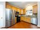 Kitchen featuring stainless steel fridge, black appliances, wooden cabinetry and granite countertops at 15623 Sir Charles Pl, Charlotte, NC 28277