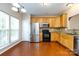 Bright kitchen featuring stainless steel appliances, granite countertops, and wooden cabinets at 15623 Sir Charles Pl, Charlotte, NC 28277