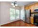 Bright kitchen features stainless steel refrigerator, eat in dining area, and wooden cabinetry at 15623 Sir Charles Pl, Charlotte, NC 28277