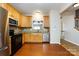 Kitchen with stainless steel dishwasher and refrigerator, wooden cabinets and granite countertops at 15623 Sir Charles Pl, Charlotte, NC 28277