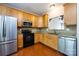 Close up view of kitchen area with wooden cabinets, stainless appliances, and granite counter tops at 15623 Sir Charles Pl, Charlotte, NC 28277