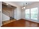 Open Living Room and dining area featuring hardwood floors and natural light at 15623 Sir Charles Pl, Charlotte, NC 28277