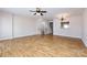 The living room features wood floors, a ceiling fan, and staircase access at 15623 Sir Charles Pl, Charlotte, NC 28277