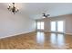 Spacious living room with wood floors, ample natural light, and a ceiling fan at 15623 Sir Charles Pl, Charlotte, NC 28277