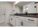 Modern bathroom with double vanity, black fixtures and tiled floor at 16042 River Tree Ln, Charlotte, NC 28278