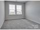 Carpeted bedroom with double window at 16042 River Tree Ln, Charlotte, NC 28278