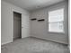 Cozy bedroom featuring plush carpet, a window, and a closet at 16042 River Tree Ln, Charlotte, NC 28278