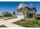 A sunny exterior view of a grey two-story home with a white garage and driveway at 16042 River Tree Ln, Charlotte, NC 28278