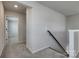 Hallway featuring neutral walls, modern railing, and carpeted floors leading to additional rooms at 16042 River Tree Ln, Charlotte, NC 28278