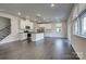 Open concept kitchen featuring white cabinets, stainless steel appliances, and hardwood floors at 16042 River Tree Ln, Charlotte, NC 28278