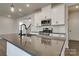This kitchen features a center island, stainless steel appliances and white cabinets and drawers at 16042 River Tree Ln, Charlotte, NC 28278