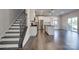Open concept kitchen features hardwood floors, a staircase, and stainless steel appliances at 16042 River Tree Ln, Charlotte, NC 28278