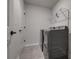 Functional laundry room with modern washer and dryer, plus convenient shelving at 16042 River Tree Ln, Charlotte, NC 28278