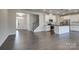 Open-concept living area with hardwood flooring, a staircase, and kitchen with stainless steel appliances at 16042 River Tree Ln, Charlotte, NC 28278