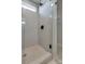 Modern shower with glass door, light tile and black shower head at 16042 River Tree Ln, Charlotte, NC 28278