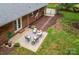 Aerial view of the backyard patio featuring comfortable outdoor seating, ideal for entertaining, and access to the brick home at 1610 Ford St, Charlotte, NC 28216