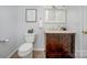 This bathroom includes a vanity with storage, tiled floors, and updated fixtures at 1610 Ford St, Charlotte, NC 28216