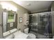 Modern bathroom with glass shower, contemporary fixtures, and gray tile at 1610 Ford St, Charlotte, NC 28216