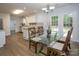 Dining area adjacent to kitchen featuring a glass table and access to the backyard at 1610 Ford St, Charlotte, NC 28216