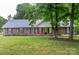 Charming brick home with a well-manicured lawn, mature trees, and inviting curb appeal at 1610 Ford St, Charlotte, NC 28216